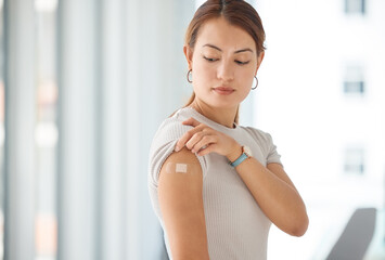 Woman with plaster on arm from covid vaccine, medical injection and corona virus cure for immune system, wellness and clinic healthcare. Asian female patient with bandaid, vaccination and flu risk