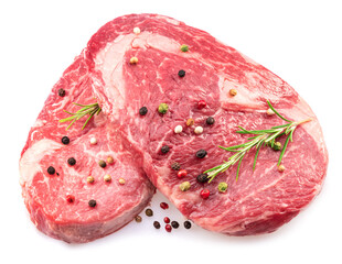 Wall Mural - Two fresh ribeye steaks with peppercorn and rosemary isolated on white background. Closeup.