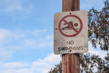 No Swimming Sign On Pole