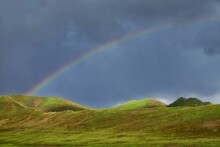 Beautiful Shot Of A Rainbow Over Green Hills