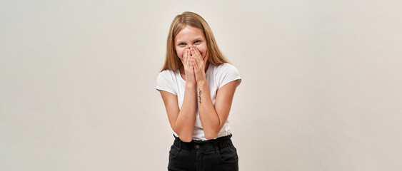 embarrassed teenage girl cover mouth on white