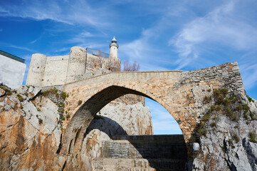 Wall Mural - The lighthouse and mediaeval bridge in Castro Urdiales.