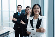 © Danai - Portrait of asian business group people in suit standing in modern office smiling raising hand celebrating success teamwork