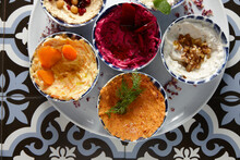 Different Flavours Of Hummus On One Plate