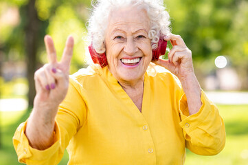 Wall Mural - Beautiful and cool senior woman portrait - Funny old grandmother doing funny poses and face expressions