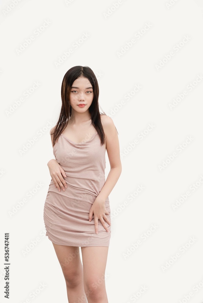 women dressed and nude Photo Stock A stunning female Asian model in a loose front dress poses for a studio shot isolated on white background Attractive Woman in Nude Elegant