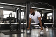 © ty - Sporty african man doing push-up in a gym.