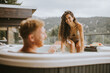 © BGStock72 - Young couple enjoying in outdoor hot tub on vacation