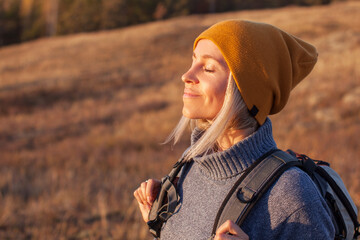 middle aged woman hiking and going camping in nature