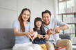 © aekkorn - Happy Asian family making mini heart symbol in living room. Family,love and happiness concept.
