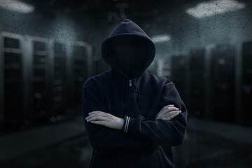 Wall Mural - A hacker stands in a server room .