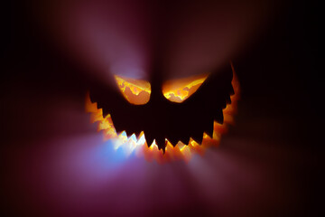 Halloween pumpkin glowing face in the dark.