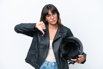 Wall Mural - Young caucasian woman with a motorcycle helmet isolated on white background showing thumb down with negative expression