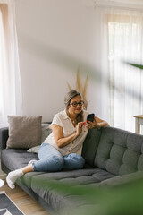 Woman using smartphone at home