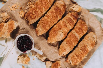 Poster - Closeup of hashasli mercimekli citir borek with a jam on a brown paper surface