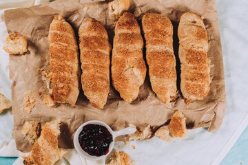 Poster - Closeup of hashasli mercimekli citir borek with a jam on a brown paper surface