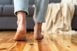 © brizmaker - close up view of woman walking barefoot indoors