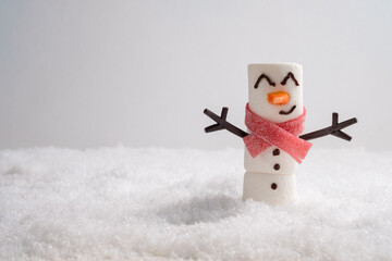 Wall Mural - Happy funny marshmallow snowman are having fun in snow. Merry Christmas card. Christmas concept