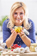 © weyo - Smiling woman holds a jar of homemade garlic preserved in oil
