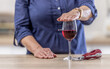 © weyo - Detail of a female hand holding palm over a glass of red wine as a sign of refusal to drink