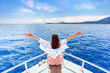 © Goffkein - Free carefree satisfied happy inspired traveler girl with open arms enjoys relaxing vacation on a white private boat in turquoise sea