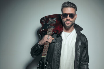 Wall Mural - rocker wearing a black leather jacket and sunglasses