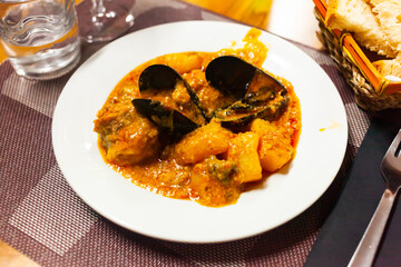 Wall Mural - Delicious mediterranean seafood stew with white fish chunks, mussels and potatoes ..