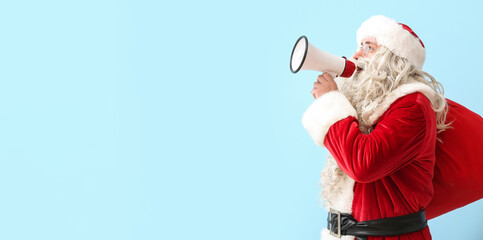 Wall Mural - Santa Claus with bag and megaphone on light blue background with space for text