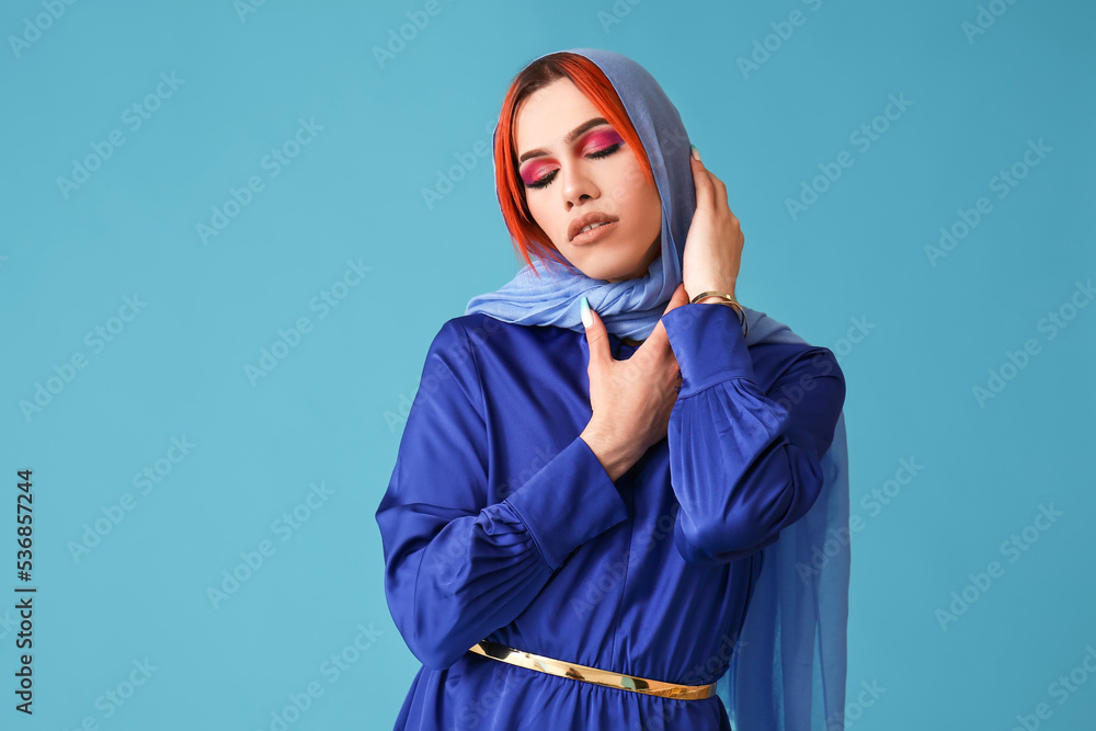 Stylish transgender woman on blue background