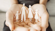 Hands holding paper family cutout, family home,life insurance, adoption foster care, homeless support , mental health, homeschooling education, Autism support, parent day