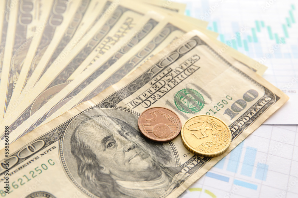 Dollar banknotes with cents on diagrams, closeup. Exchange rate concept