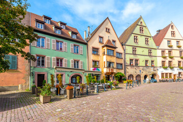 Wall Mural - Picturesque half timber buildings housing shops, cafes and homes in the historical town of Kaysersberg-Vignoble, France, in the Alsace region.