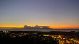 Fototapeta Niebo - Sunset behind Moorea Island with Faa'a International Airport in the foreground at night