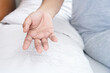 © doucefleur - closeup hand holding hair loss fallen on pillow