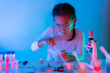 asian girl with science experiment working education concept, with blue light and red