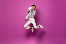 Energetic Trendy Young African American Woman Jumping With Megaphone In Studio Purple Pink Color Isolated Background