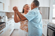 © Beaunitta V W/peopleimages.com - Happy senior couple, dance and laughing in joyful happiness for relationship bonding in the kitchen at home. Elderly man and woman with smile dancing together for romantic moment in love and care