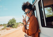 © Kay Abrahams/peopleimages.com - Travel, van and woman with peace hand sign on road trip in Mexico, happy, relax and smile. Summer, nature and journey in a countryside with a black woman excited about adventure and hipster lifestyle