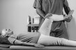 © Microgen - Physical Therapist Working with Leg. Senior Woman