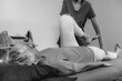 © Microgen - Physical Therapist Working with Leg. Senior Woman