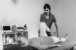 © Microgen - Physical Therapist Working with Leg. Senior Woman