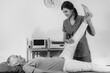 © Microgen - Physical Therapist Working with Leg. Senior Woman