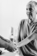 © Microgen - Therapist Checking Senior Woman’s Arm