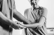 © Microgen - Therapist Checking Senior Woman’s Arm