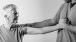 © Microgen - Therapist Checking Senior Woman’s Arm