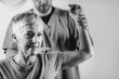 © Microgen - Therapist Checking Senior Woman’s Shoulder