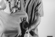 © Microgen - Therapist Checking Senior Woman’s Shoulder