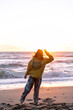 girl on beach at sunset wearing hat with Oregon shirt