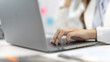 © Puwasit Inyavileart - Businesswoman's hand presses on a laptop keyboard, World of technology and internet communication, Using computers to conduct financial transactions because the convenience and speed.