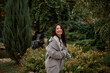 © olga pink - Portrait of pretty asian kazakh brunette woman with charming smile walking along outdoors